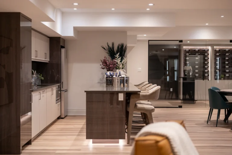 Finished basement with wet bar, island seating and warm recessed lighting