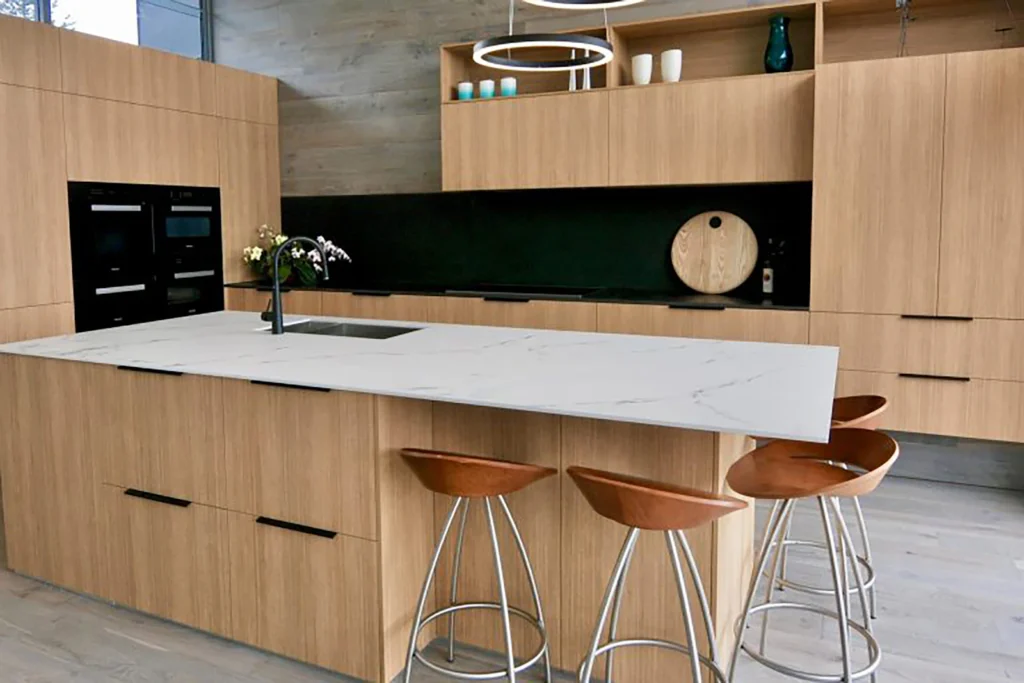 Kitchen with warm wood island, stone countertop and bar seating