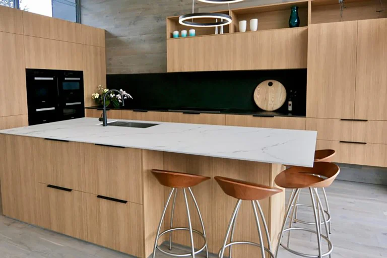 Kitchen with warm wood island, stone countertop and bar seating